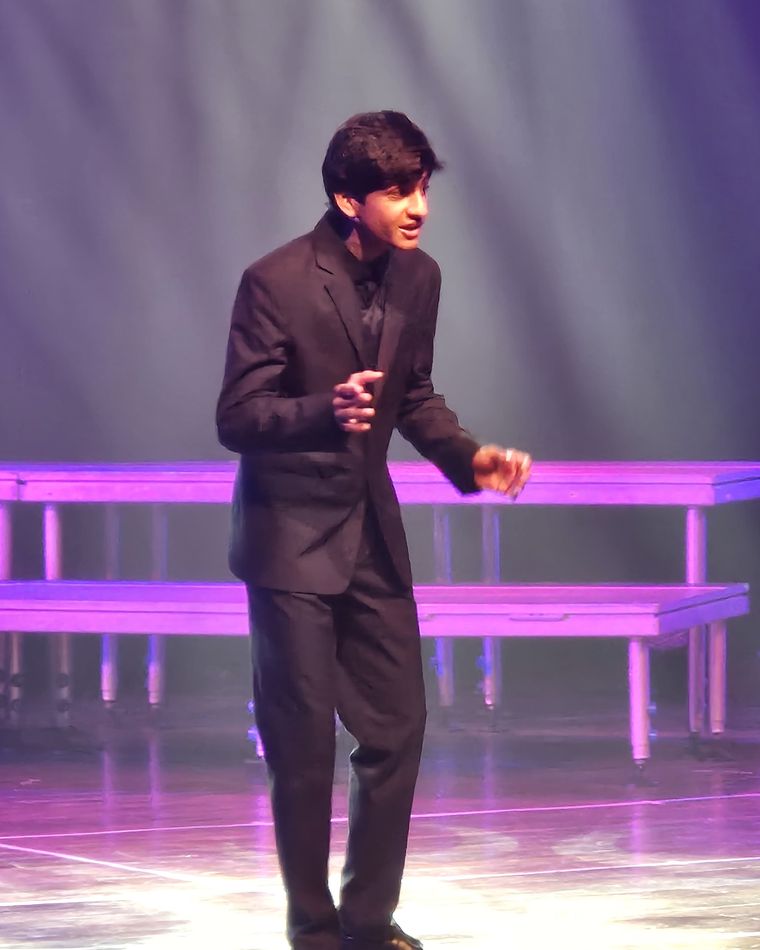 Vihaan Sethi speaking on stage at a World Scholar's Cup round
